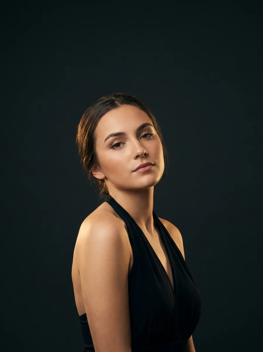 A woman posing in a studio, coached by CoverPose